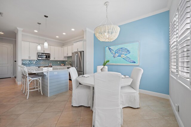 dining space featuring ornamental molding, an inviting chandelier, and light tile patterned floors