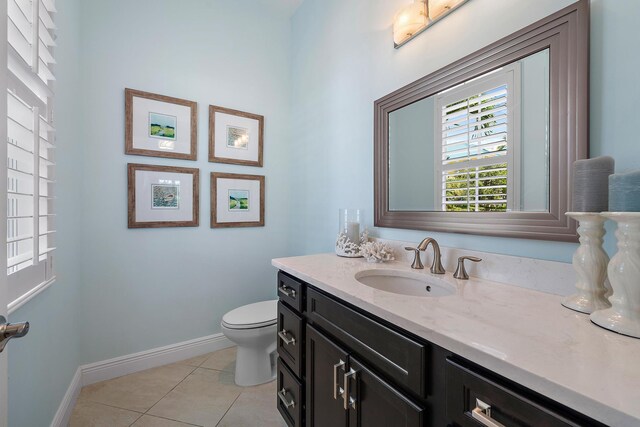 bathroom with vanity, toilet, and tile patterned flooring