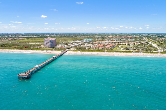 drone / aerial view featuring a beach view and a water view