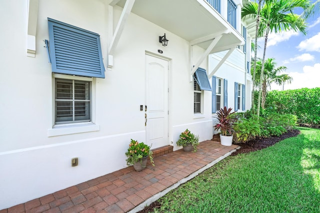 entrance to property with stucco siding