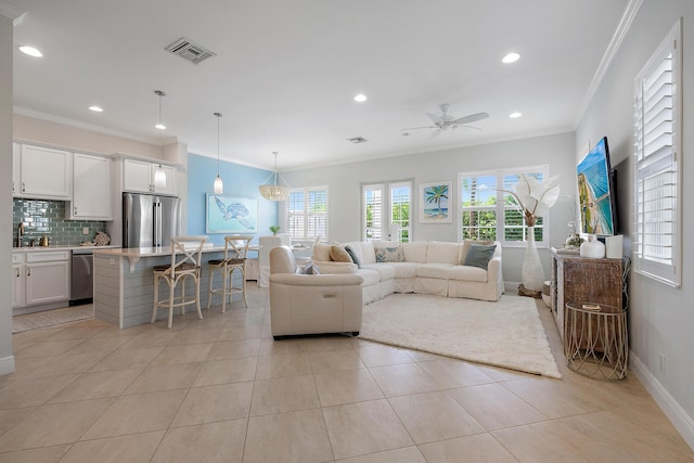 living area featuring ornamental molding, visible vents, baseboards, and light tile patterned flooring