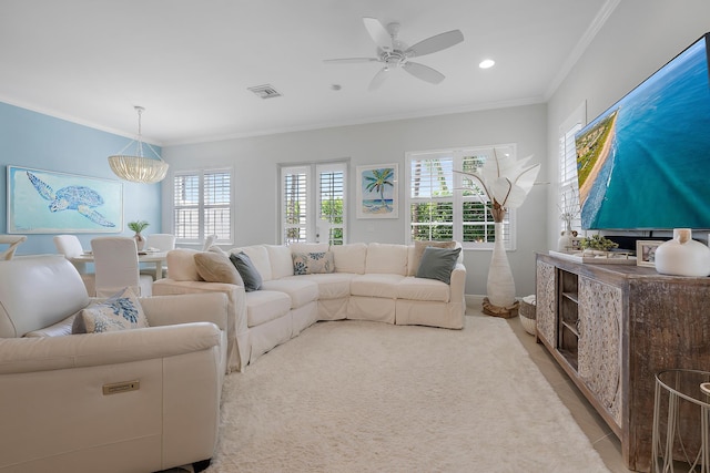 living room with light tile patterned floors, recessed lighting, ceiling fan with notable chandelier, visible vents, and ornamental molding