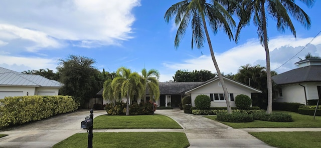 ranch-style home with a front lawn