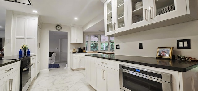 kitchen featuring appliances with stainless steel finishes, white cabinetry, and sink