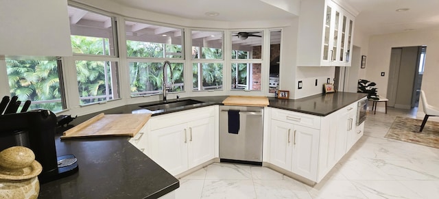 kitchen featuring plenty of natural light, stainless steel appliances, sink, and white cabinetry