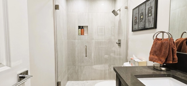 bathroom featuring vanity, toilet, and an enclosed shower