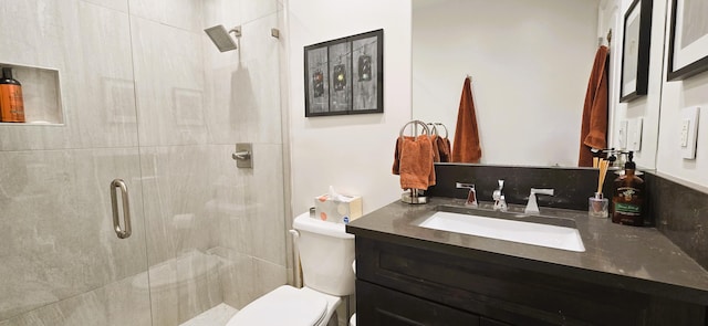 bathroom with vanity, toilet, and an enclosed shower