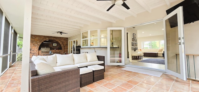 interior space with wood ceiling, beamed ceiling, and ceiling fan