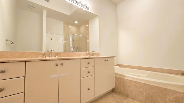 bathroom featuring tile patterned flooring, vanity, and plus walk in shower