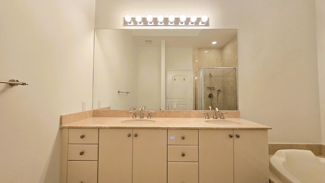 bathroom with vanity and separate shower and tub