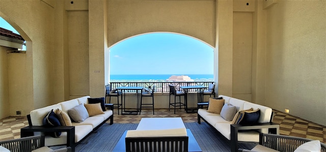 exterior space featuring an outdoor living space, a water view, and a patio area