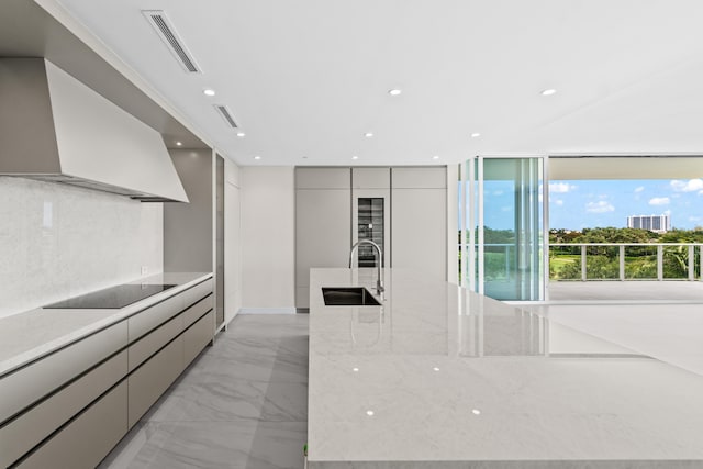 220 SE Mizner Blvd Unit 523, Boca Raton, FL 33432 - kitchen with modern cabinets, a sink, light marble finish floors, black electric stovetop, and recessed lighting