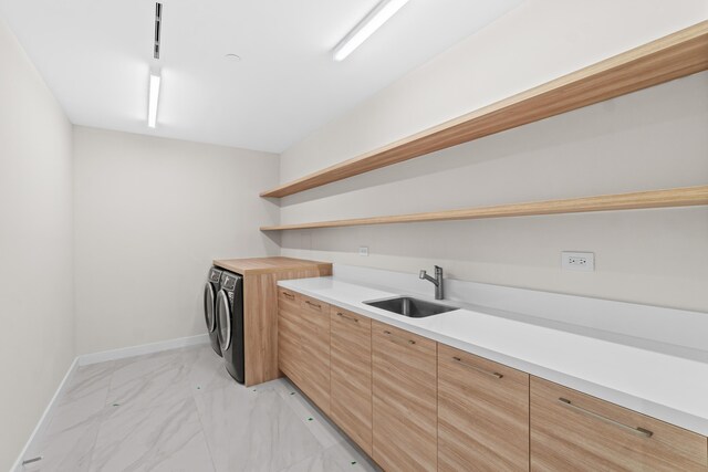 220 SE Mizner Blvd Unit 523, Boca Raton, FL 33432 - laundry room with washing machine and clothes dryer, light marble finish flooring, and baseboards