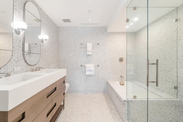 full bathroom featuring vanity, toilet, tile walls, and plus walk in shower