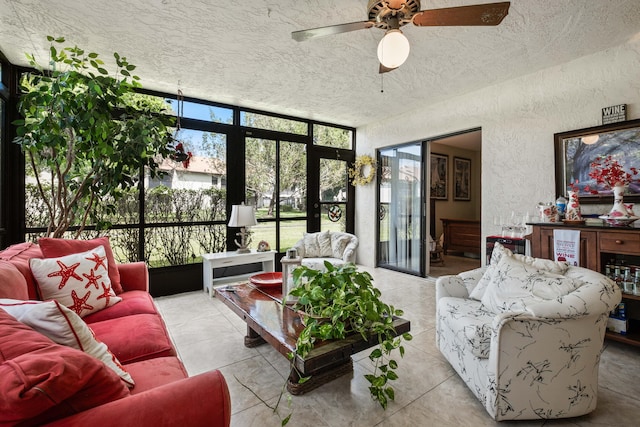 living room with a wall of windows, ceiling fan, a wealth of natural light, and a textured ceiling