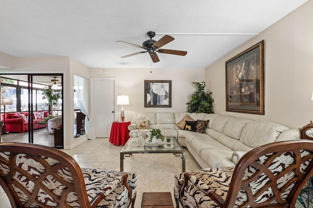 living room featuring a textured ceiling, ceiling fan, and light tile patterned floors