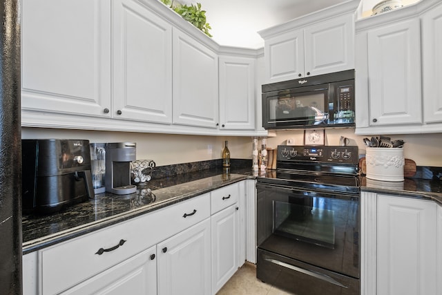 kitchen featuring black appliances, dark stone countertops, white cabinetry, and light tile patterned flooring