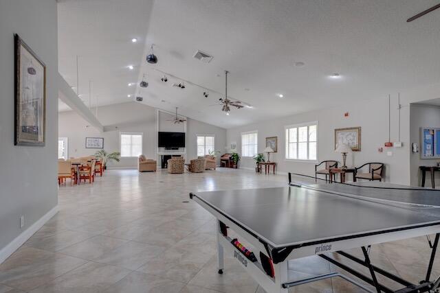 game room with lofted ceiling and ceiling fan