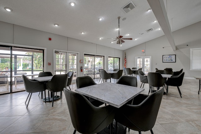 dining room with plenty of natural light, ceiling fan, high vaulted ceiling, and french doors