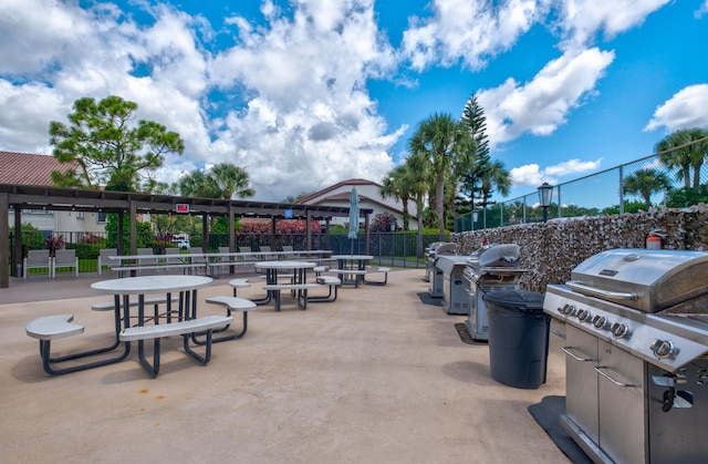 view of property's community with an outdoor kitchen and a patio area