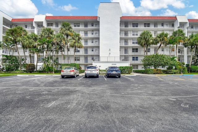 view of building exterior with uncovered parking