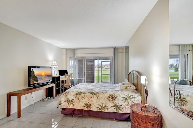 bedroom with multiple windows and light tile patterned floors