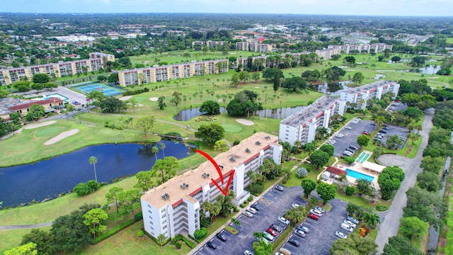 bird's eye view with a water view and view of golf course