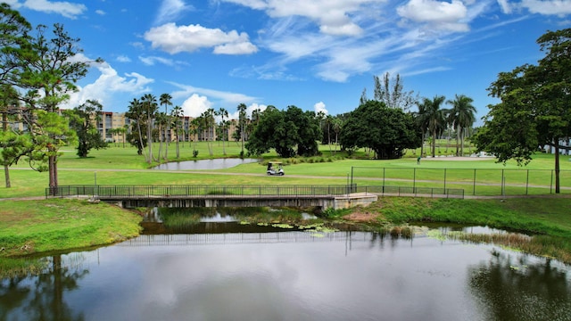 view of home's community featuring a lawn and a water view