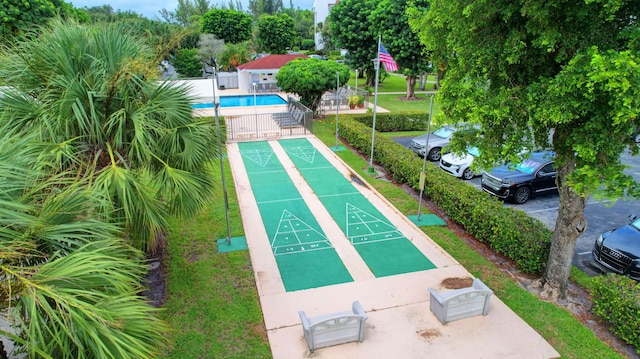 view of home's community featuring a gate, fence, shuffleboard, and a pool