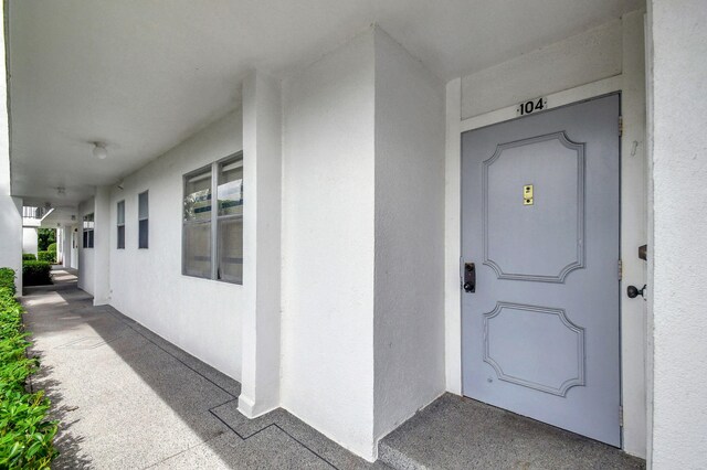 view of exterior entry featuring stucco siding