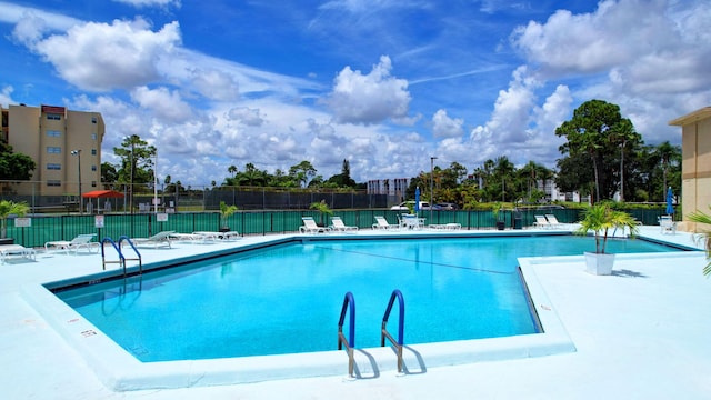 community pool featuring a patio and fence