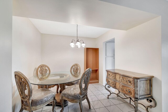 tiled dining area with an inviting chandelier