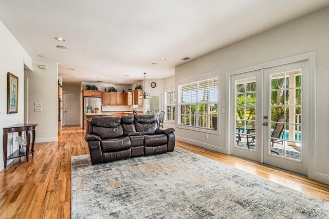 living room featuring light hardwood / wood-style floors and french doors