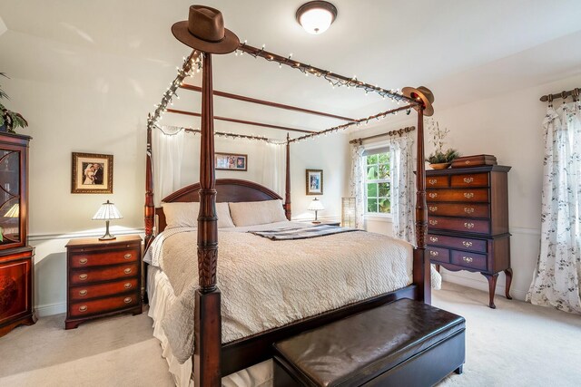 bedroom featuring light colored carpet