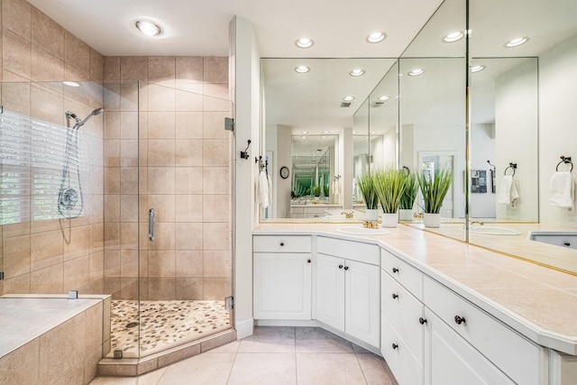 bathroom featuring tile patterned flooring, vanity, and an enclosed shower