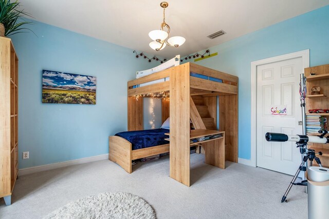 bedroom with an inviting chandelier and light colored carpet