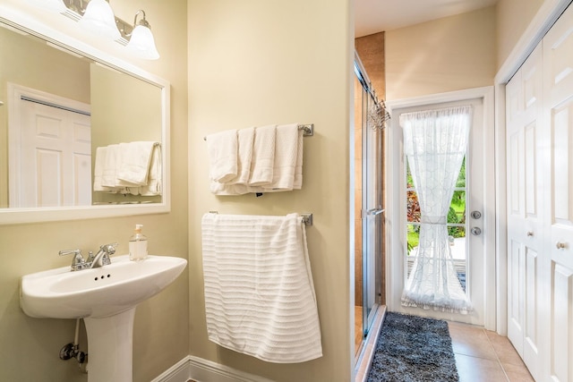 bathroom with tile patterned flooring and an enclosed shower