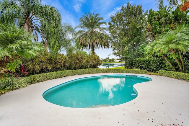 view of swimming pool featuring a water view