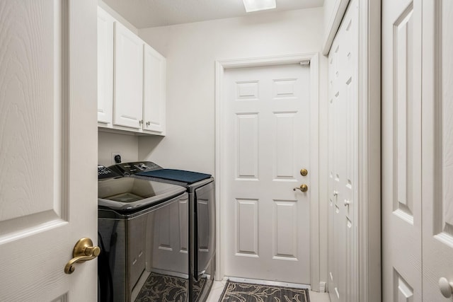 laundry room featuring cabinets and washing machine and dryer