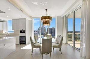 dining room with a wealth of natural light, expansive windows, and a chandelier