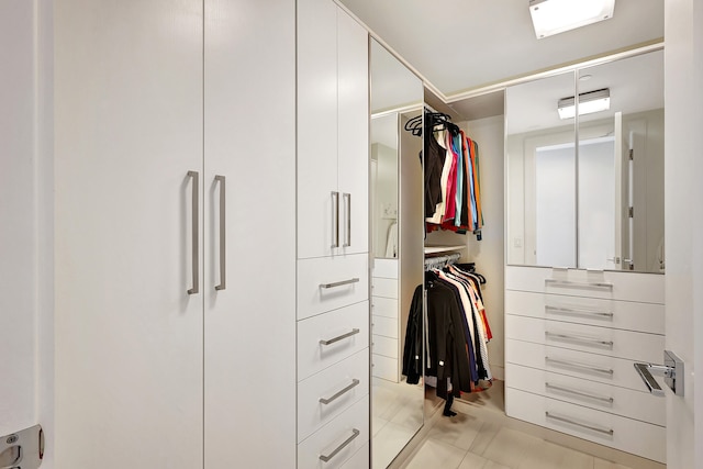 spacious closet with light tile patterned floors