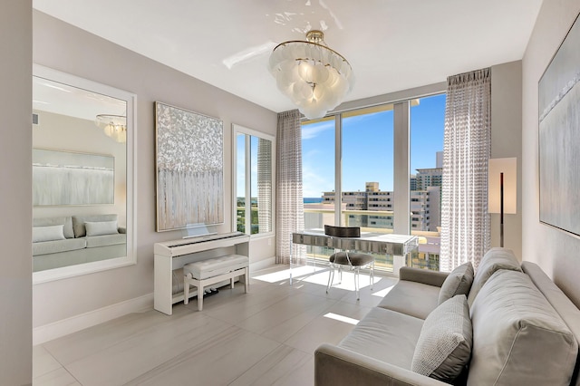 living room with a wall of windows, baseboards, and a chandelier