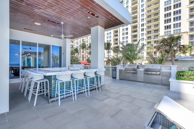 view of patio with a grill, exterior kitchen, and outdoor wet bar