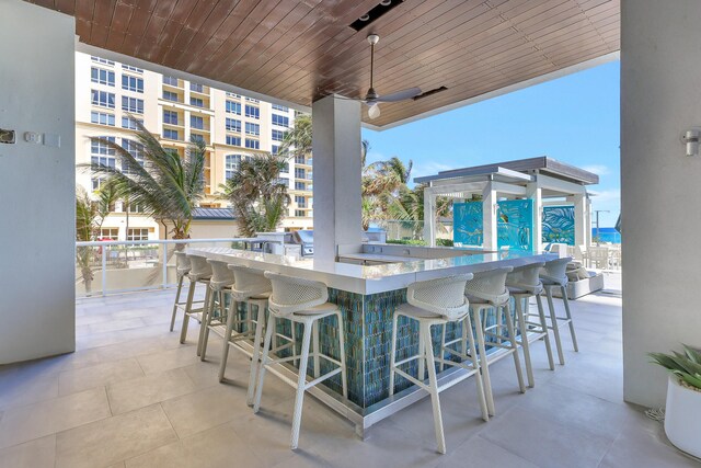 view of patio / terrace with an outdoor bar and ceiling fan