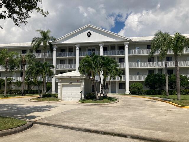 view of building exterior with driveway and a garage