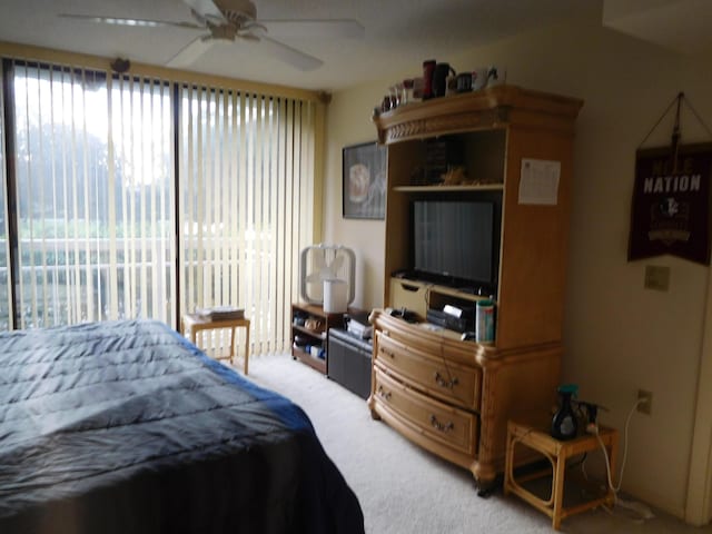 carpeted bedroom featuring access to outside and ceiling fan