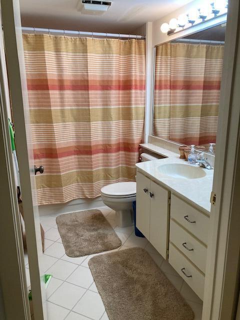 bathroom featuring tile patterned floors, vanity, toilet, and a shower with shower curtain