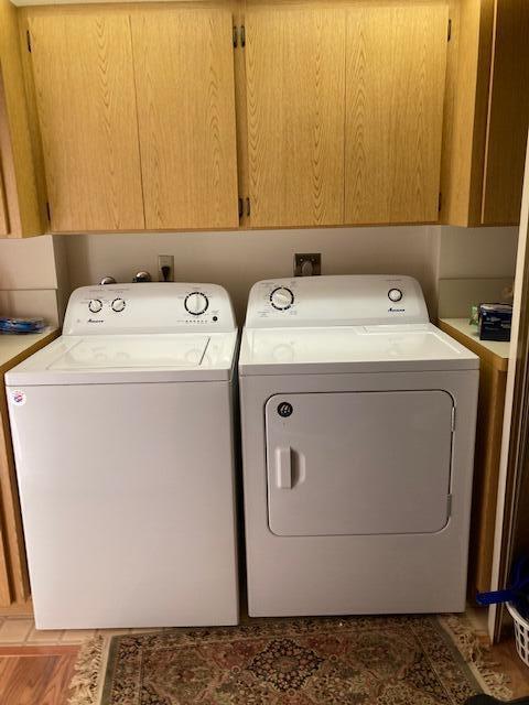 laundry area with cabinet space and separate washer and dryer