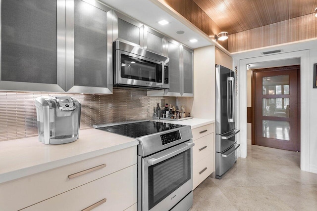 kitchen with appliances with stainless steel finishes and tasteful backsplash