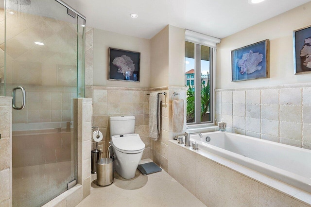 bathroom with tile walls, toilet, independent shower and bath, and tile patterned floors